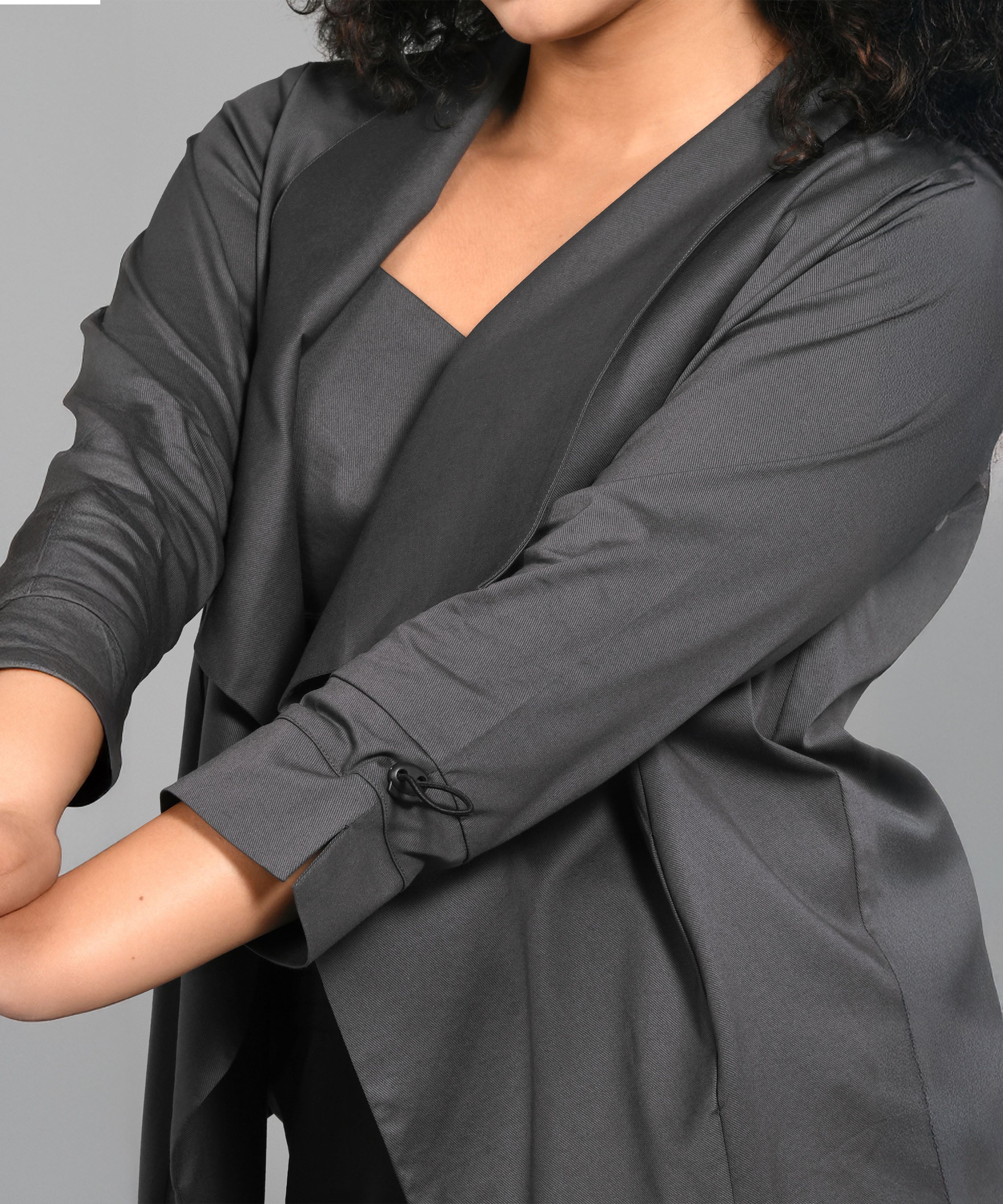 Woman wearing the Timeless Brilliance Grey Co-ord Set with a cropped long-sleeve top and matching yoga pants, standing against a plain gray background.