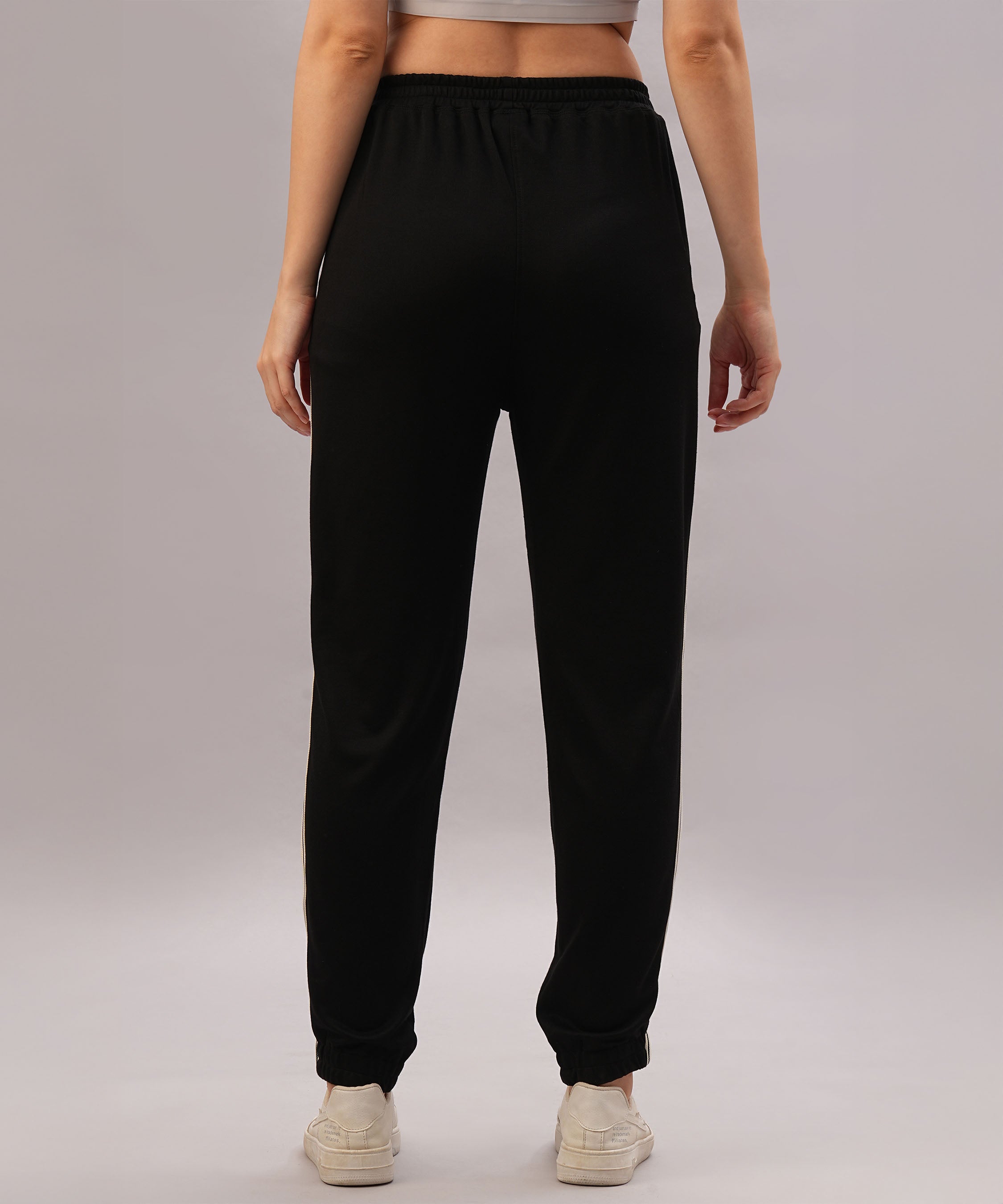 Model wears the Black Co-Ord Set, seen from the back against a plain background—a sleek, coordinated outfit made from comfortable cotton lycra and styled with white sneakers.