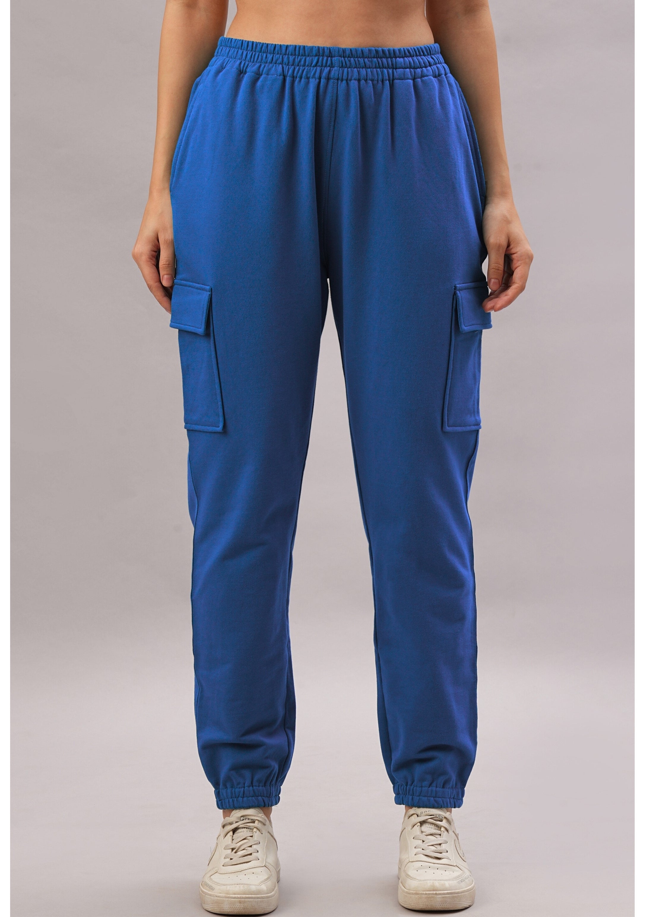 A person wears the Soft Royal Blue Trackset cargo-style joggers in a breathable cotton-viscose blend with white sneakers, standing against a plain background.