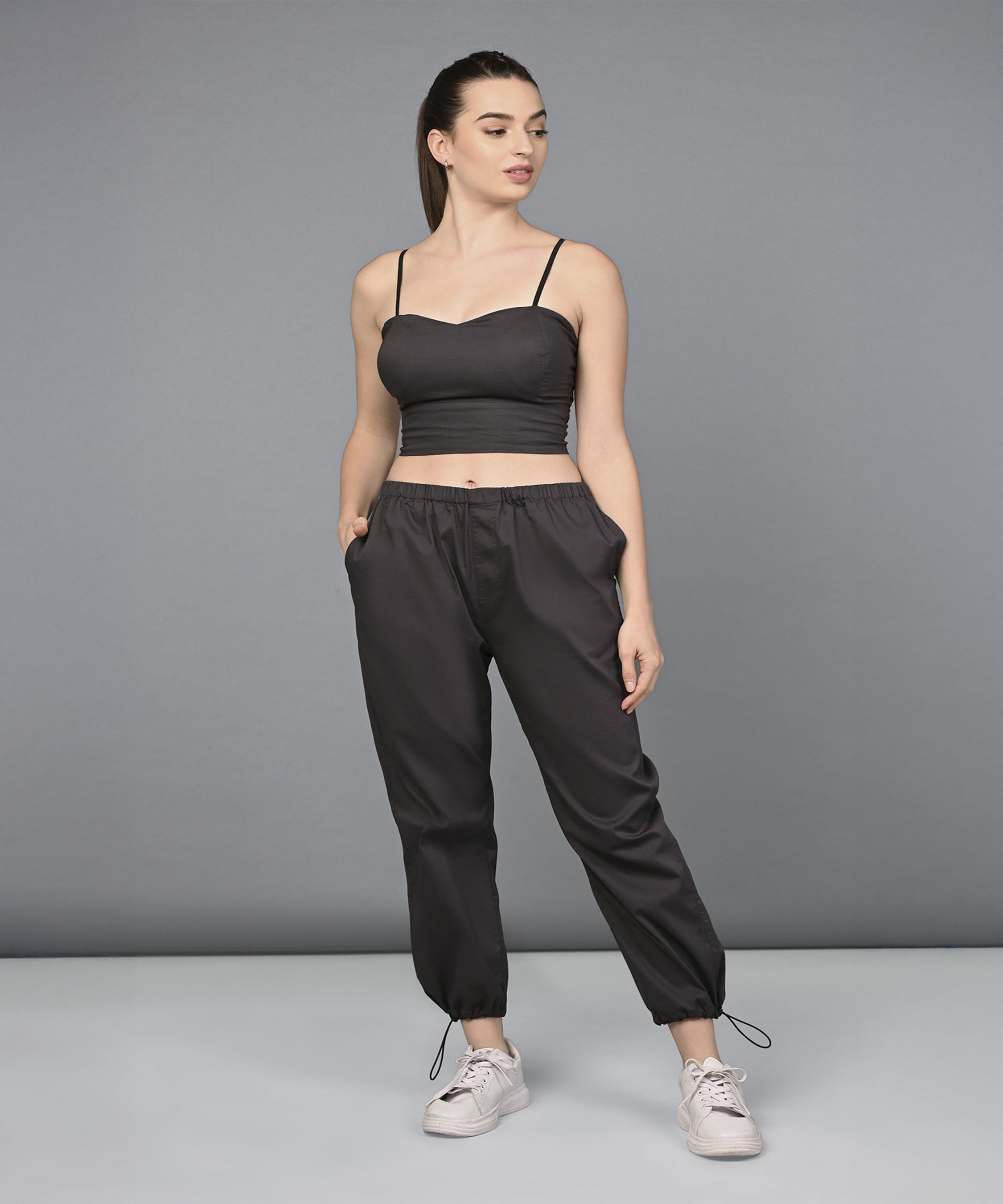 Woman wears the Athleisure Blazer Tracks Two Piece Co-ord Set, standing with hands in pockets against a gray background.