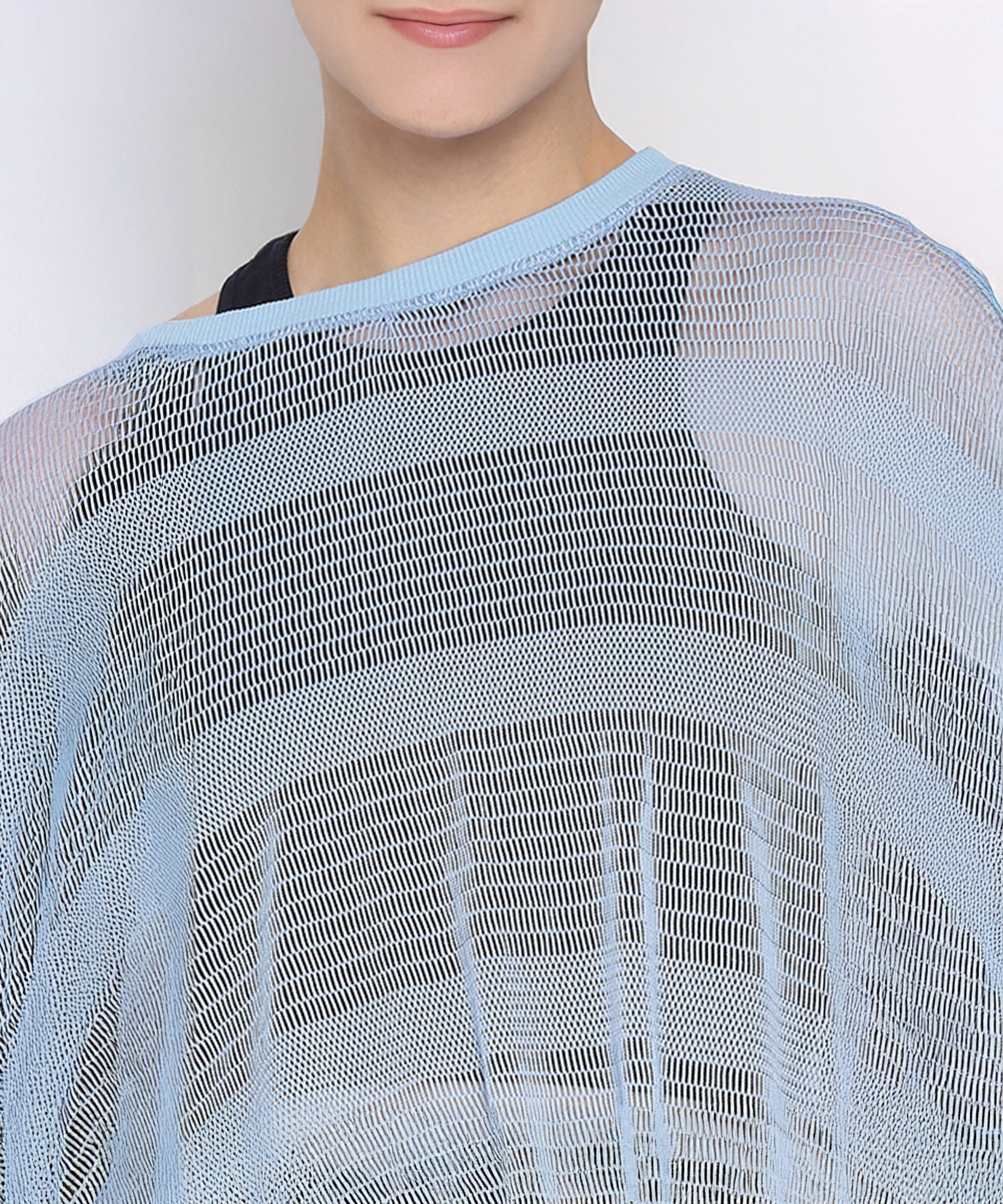 Model wears the Blue Netted Top over a black shirt, visible from shoulders to mouth, for a subtle sporty look against a plain background.