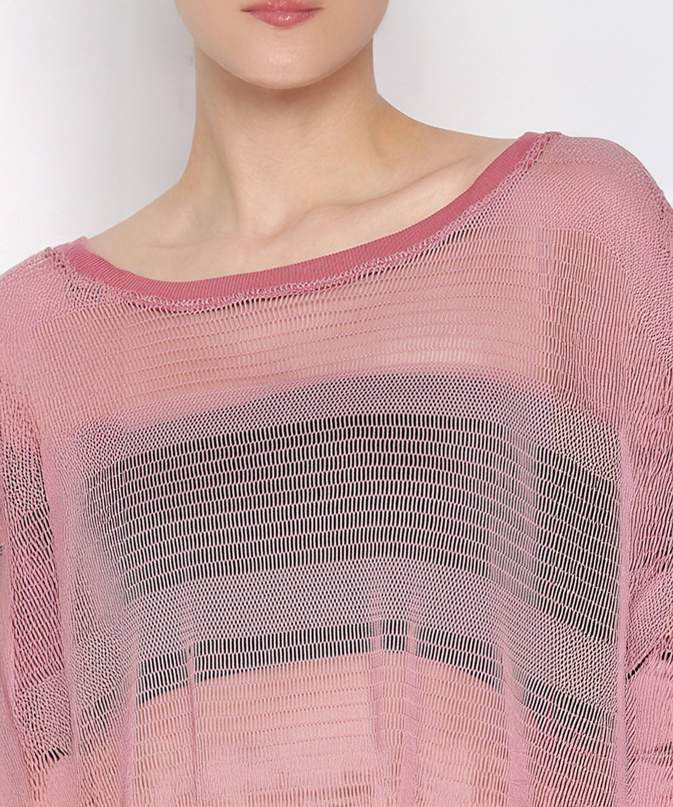 Wearing the Pink Netted Top with a wide neckline and sheer pink knit design, paired with stylish leggings and visible black stripes underneath, creates a sporty and fashionable look.