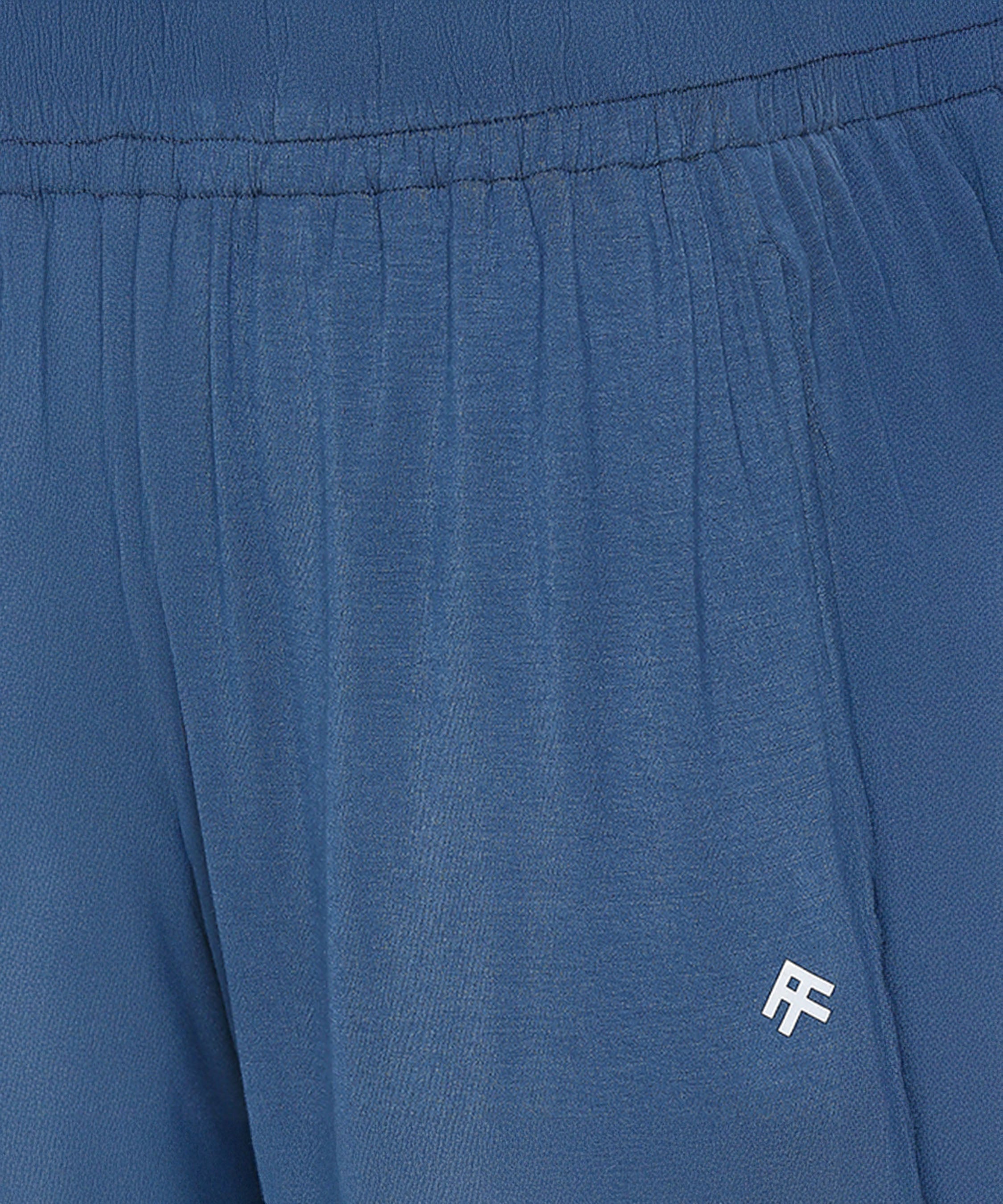 Close-up of Atlantic Blue Active Duo joggers with an elastic waistband, crafted from buttery soft fabric and featuring a small white "RF" logo on the pocket.