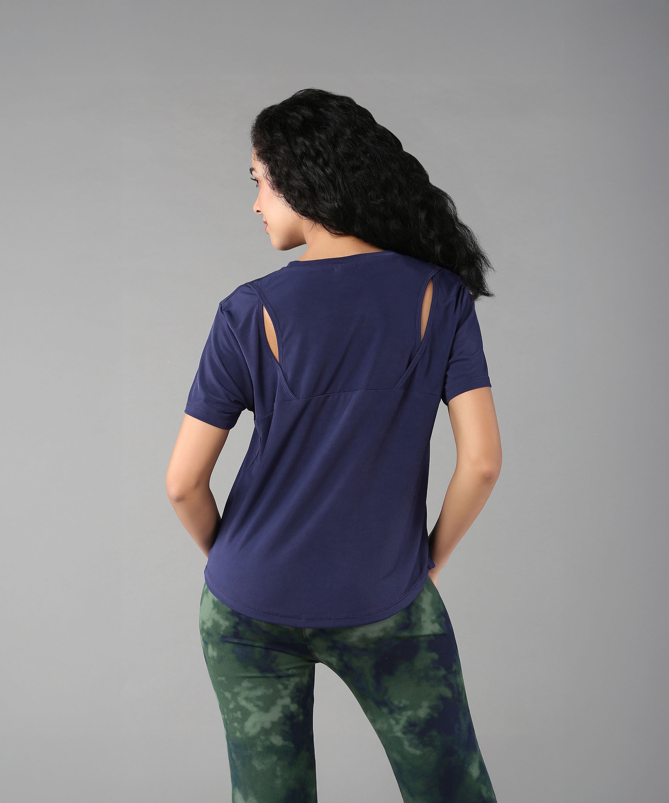 Woman with long black hair wears the Functional - Blue Soft T Shirt, made from a durable poly blend for comfort and style—perfect for versatile outdoor outfits.