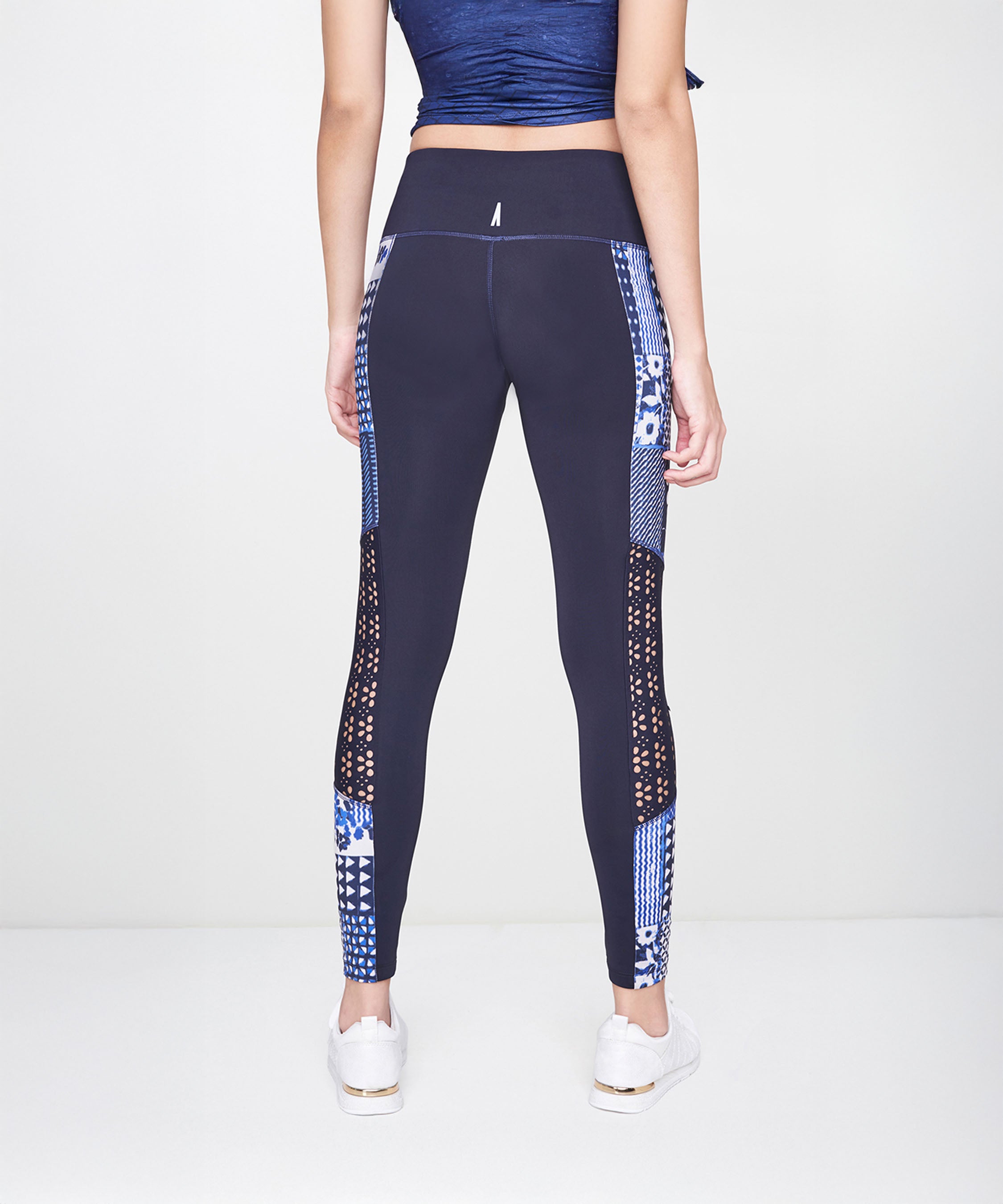 Woman wearing the Indigo Printed Top With Leggings, shown from the back against a plain background, exudes effortless athleisure style.