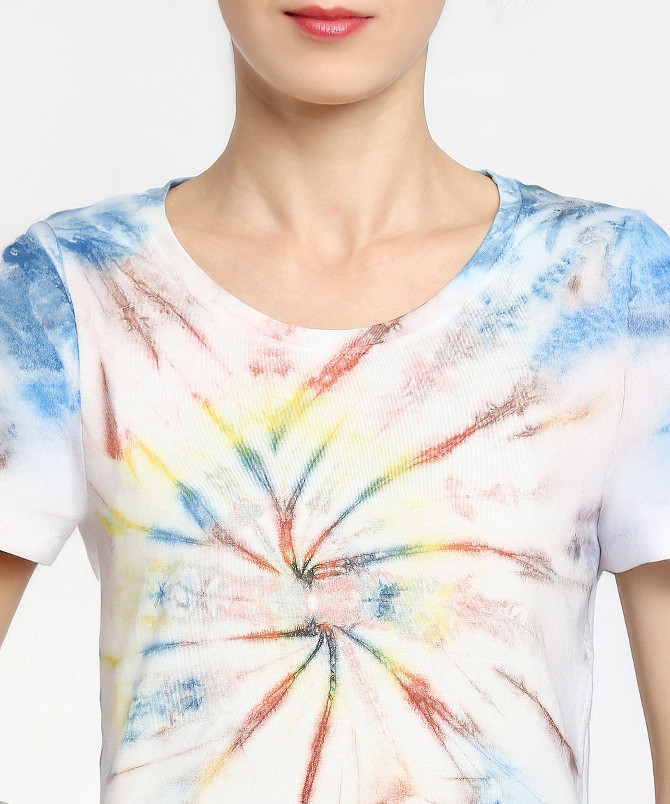 Person wearing the Netted shorts + comfort tee in white cotton with colorful spiral tie-dye patterns, visible from shoulders to chest. Made using eco-friendly dyes for a vibrant, sustainable style.