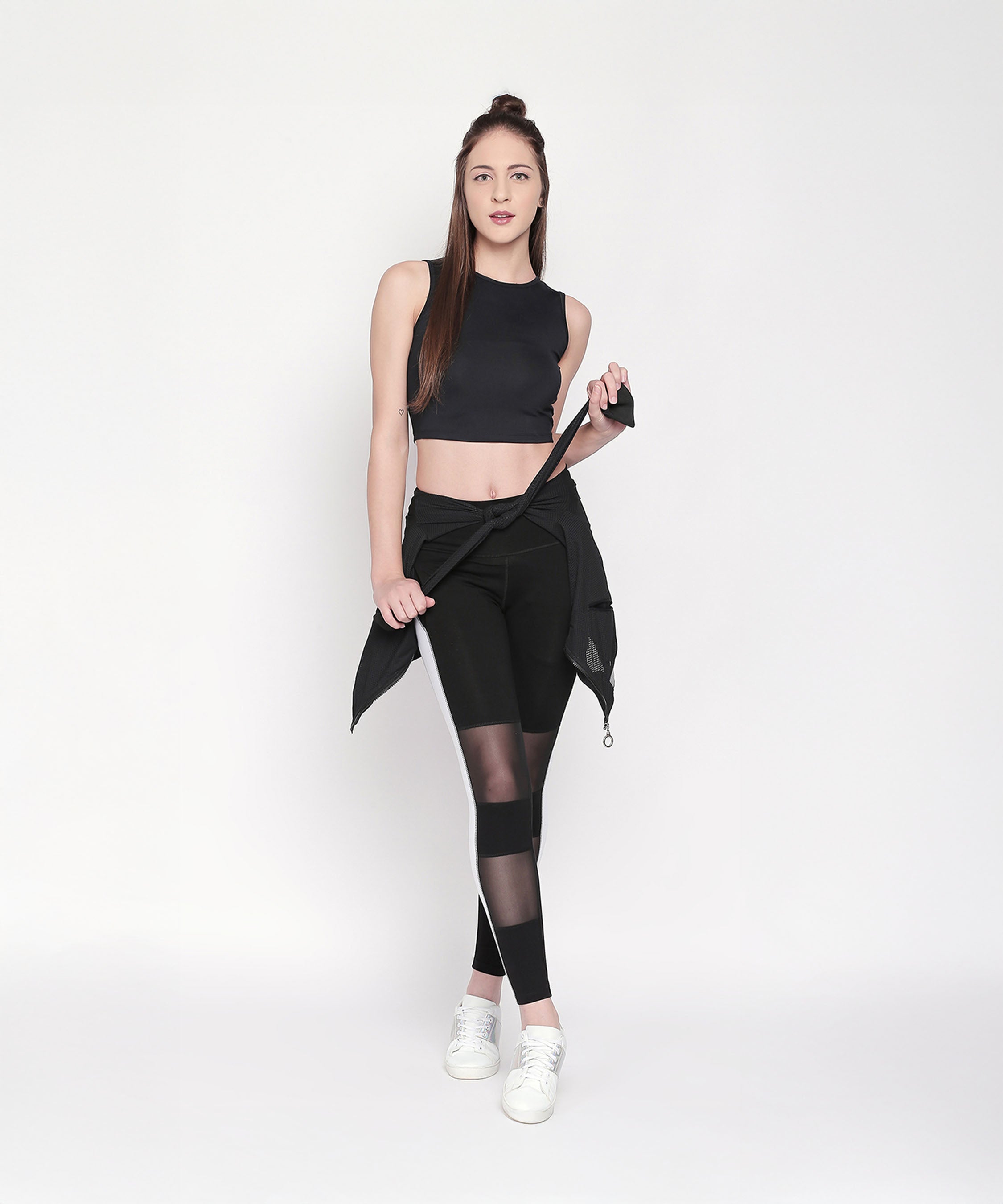 Model wearing Black and White High Waisted Leggings - LG13 with white sneakers poses against a plain white background.