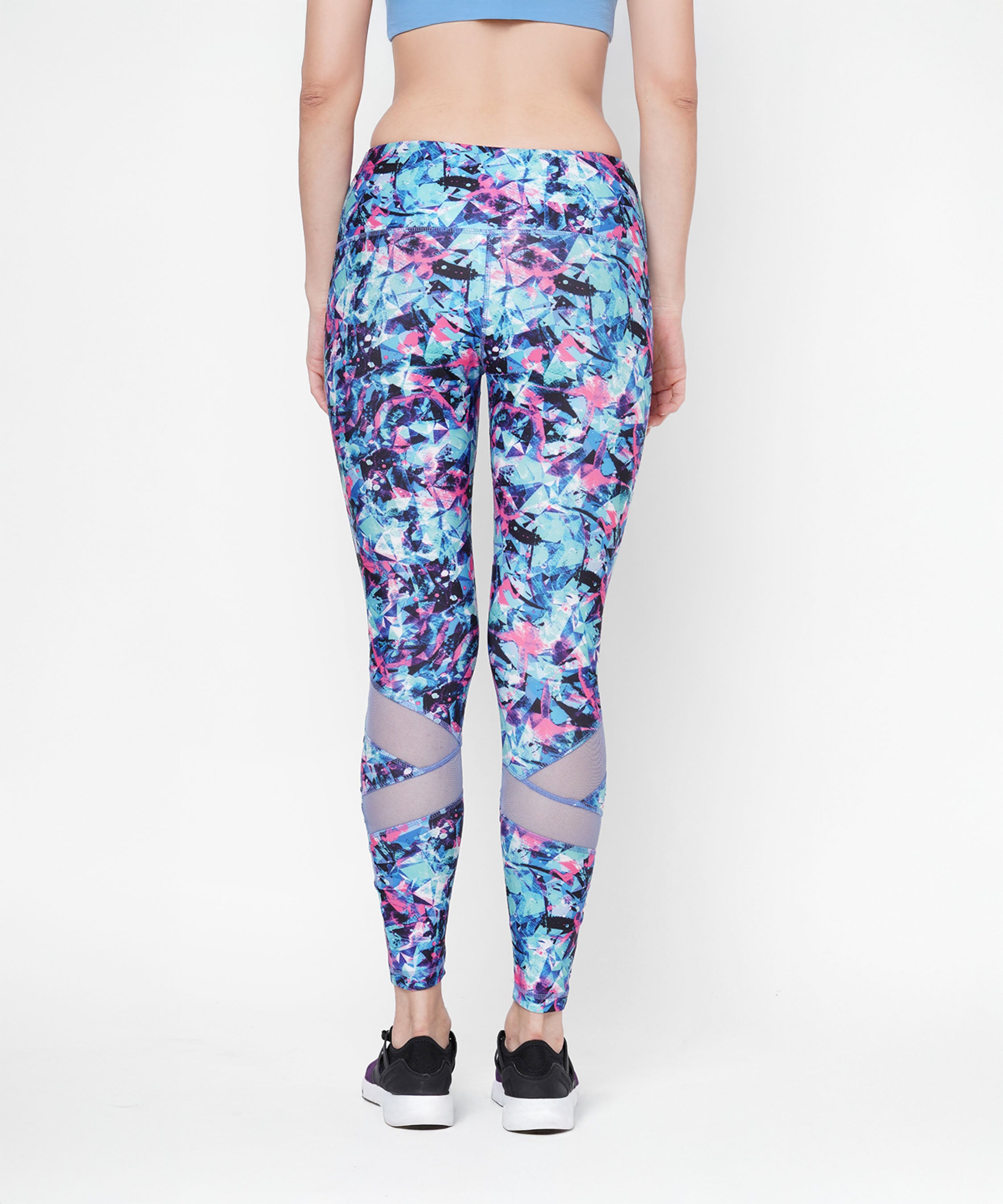 Woman shown from the back against a white background wearing high-waisted Amira Printed Leggings and black sneakers.