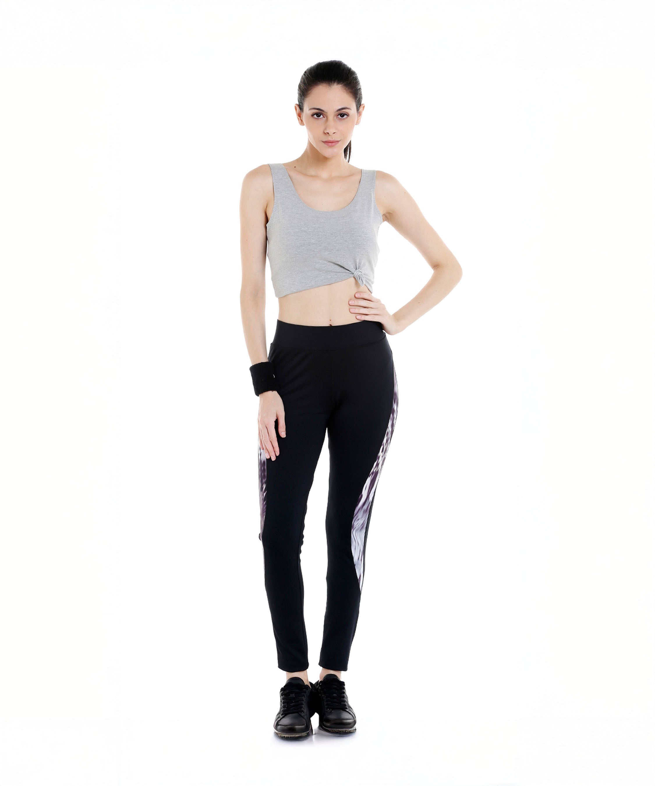 Woman in a gray crop top and Black Sports Leggings G2 with an elasticated waistband, standing against a white background, facing forward.
