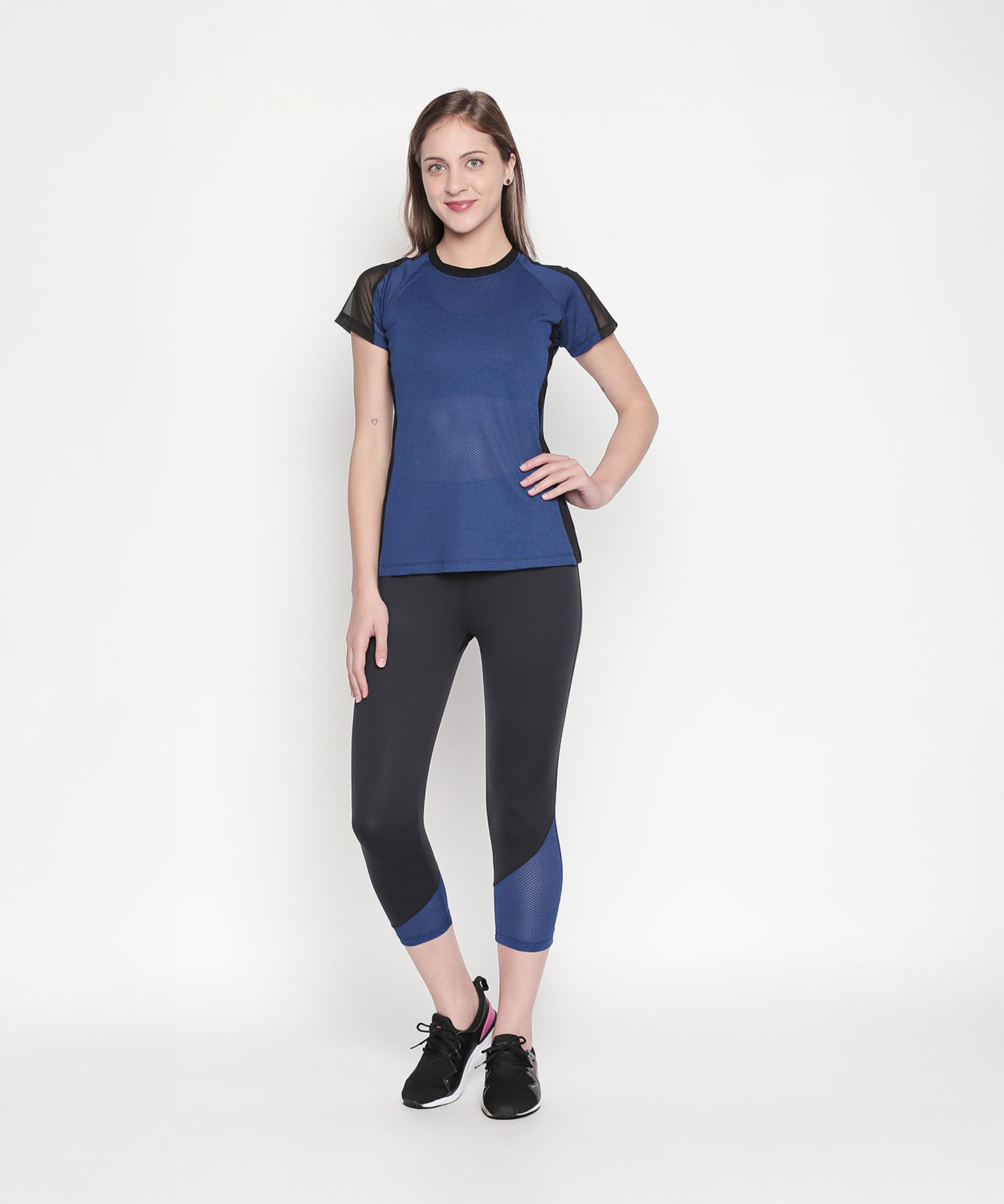 Woman wearing the Sportswear Dark Blue Tracksuit, standing and smiling against a plain white background, ready for an energizing workout.
