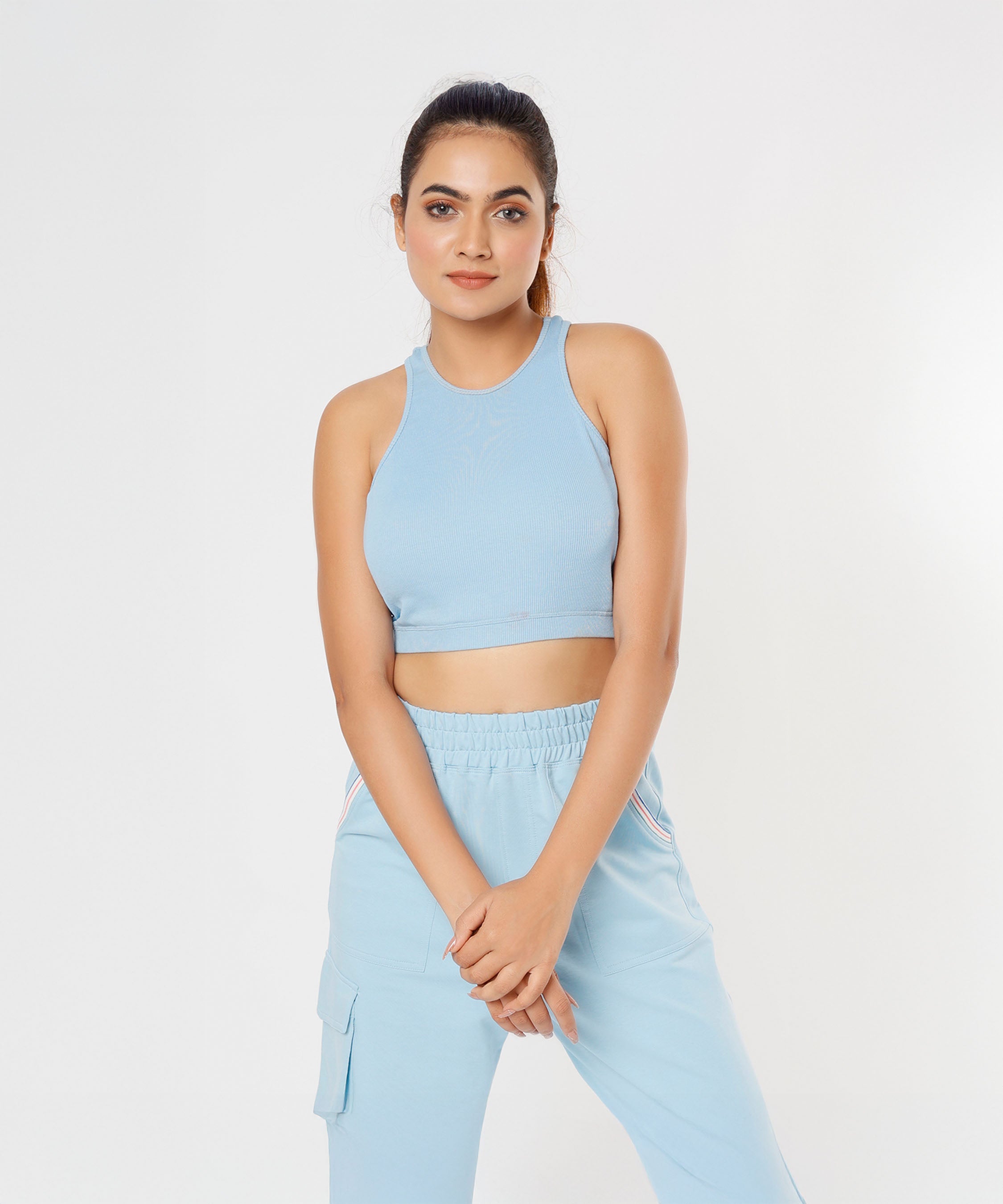 A woman poses gracefully against a plain white background wearing the Blue Dream Crop Top.