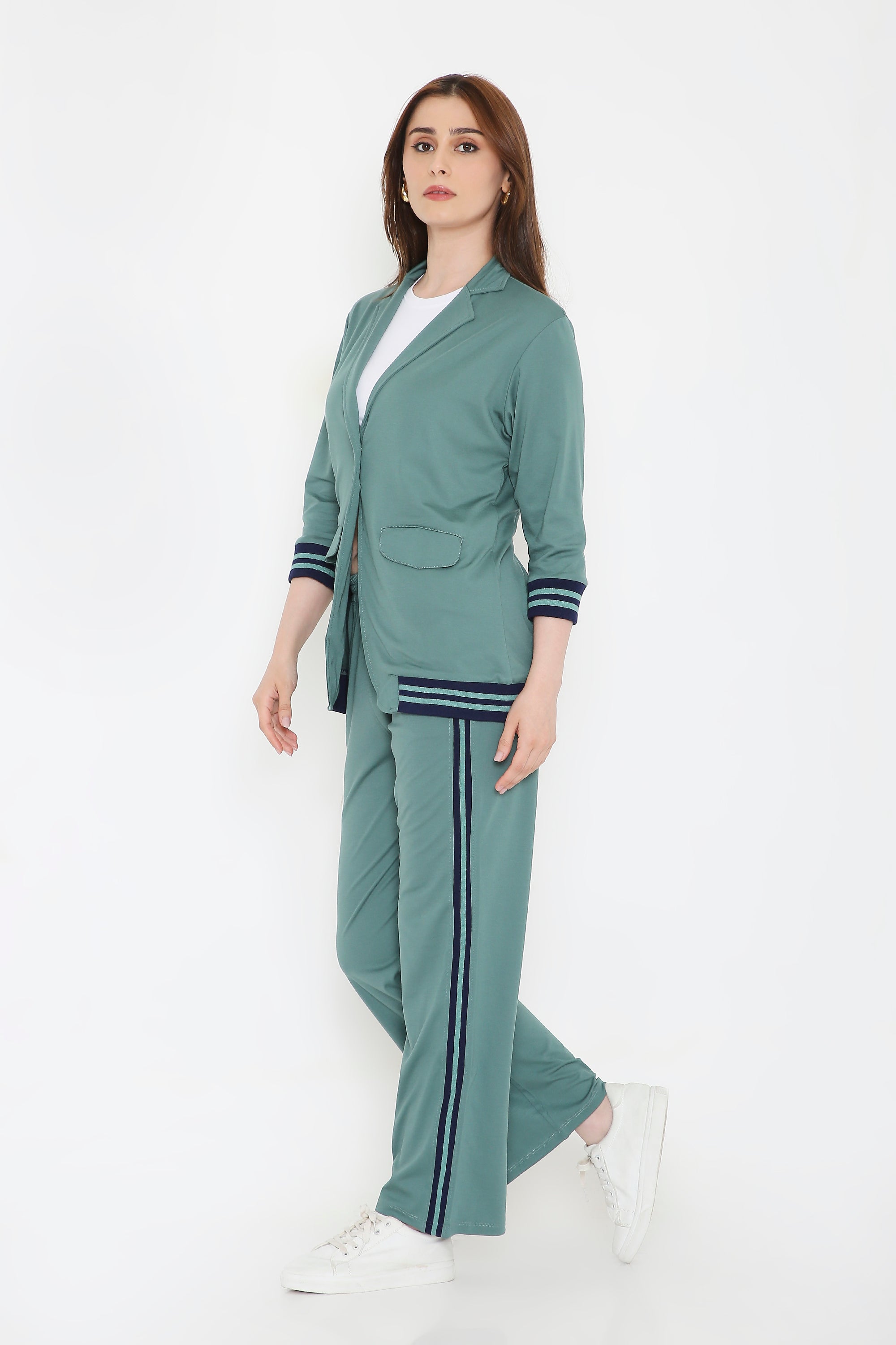 Woman wearing the Sage Green Athleisure Blazer Jacket and Track Set, paired with a white shirt and sneakers, standing against a white background.