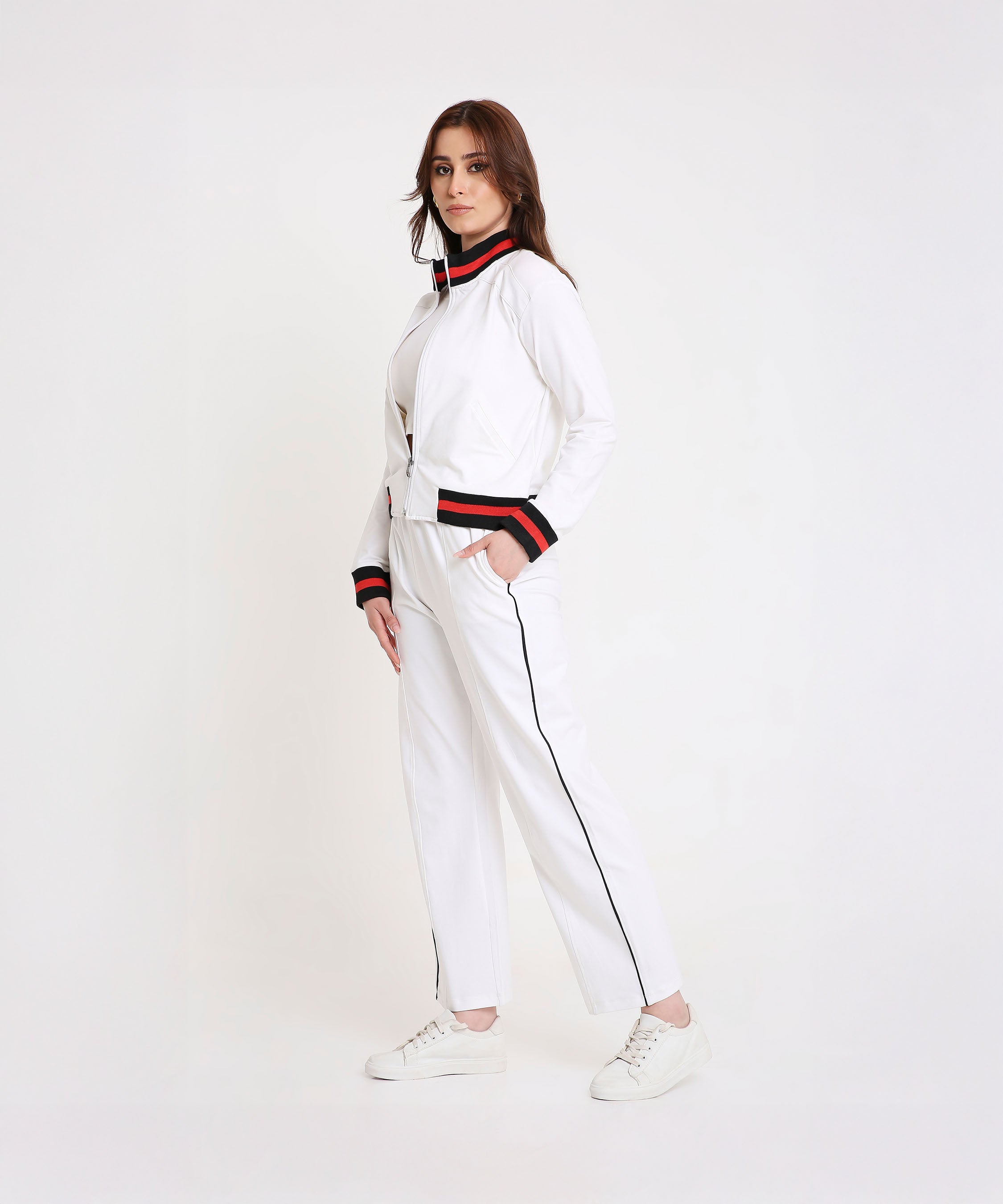 Model wearing the Two Piece Bold Contrast White Tracksuit in soft cotton-blend fabric with black and red trim, posing against a white background for a sporty-chic look.