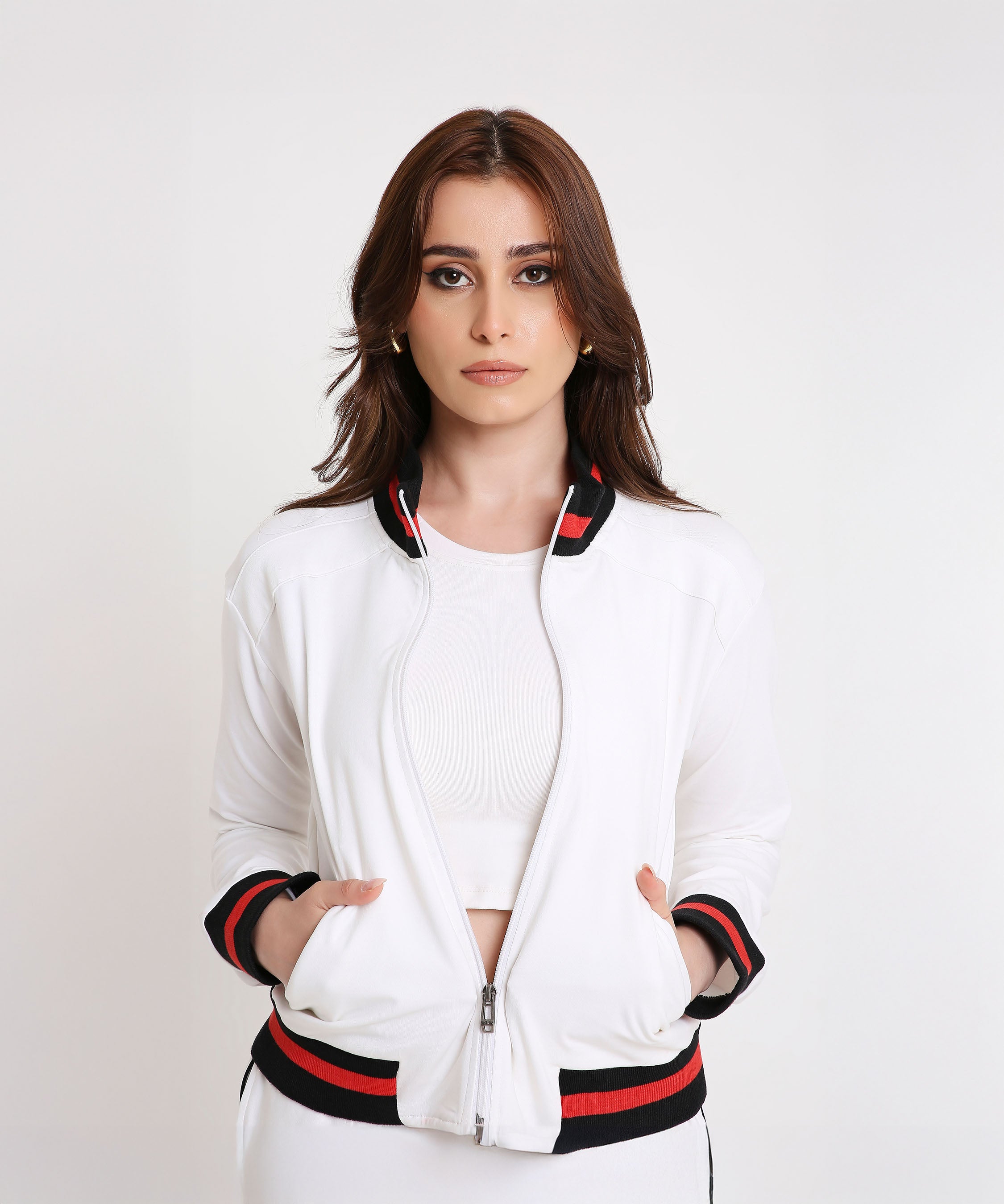 Model wearing the Two Piece Bold Contrast White Tracksuit in soft cotton-blend fabric with black and red trim, posing against a white background for a sporty-chic look.
