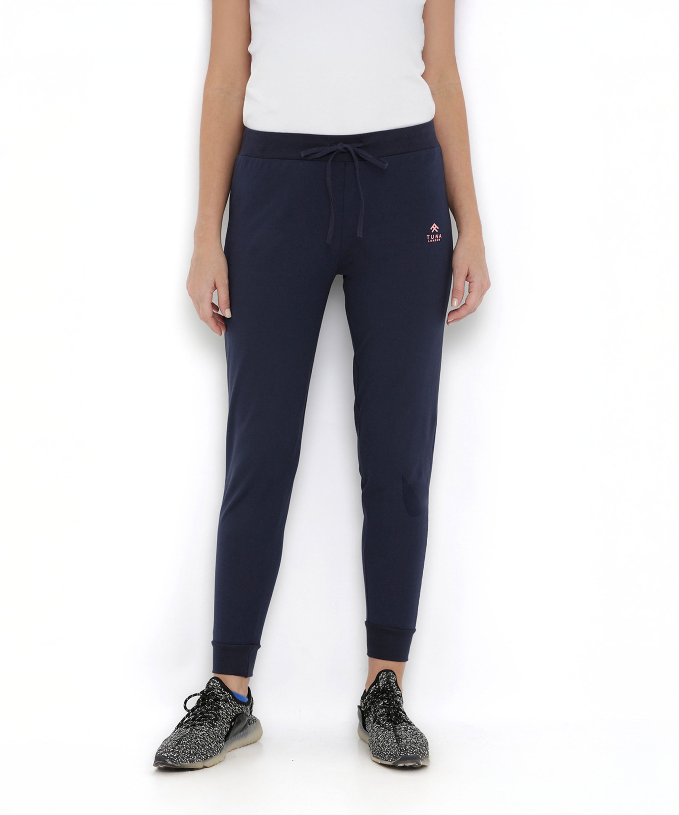 Person wearing a white top, Blue Classic Joggers TLC04, and black sneakers stands against a white background.