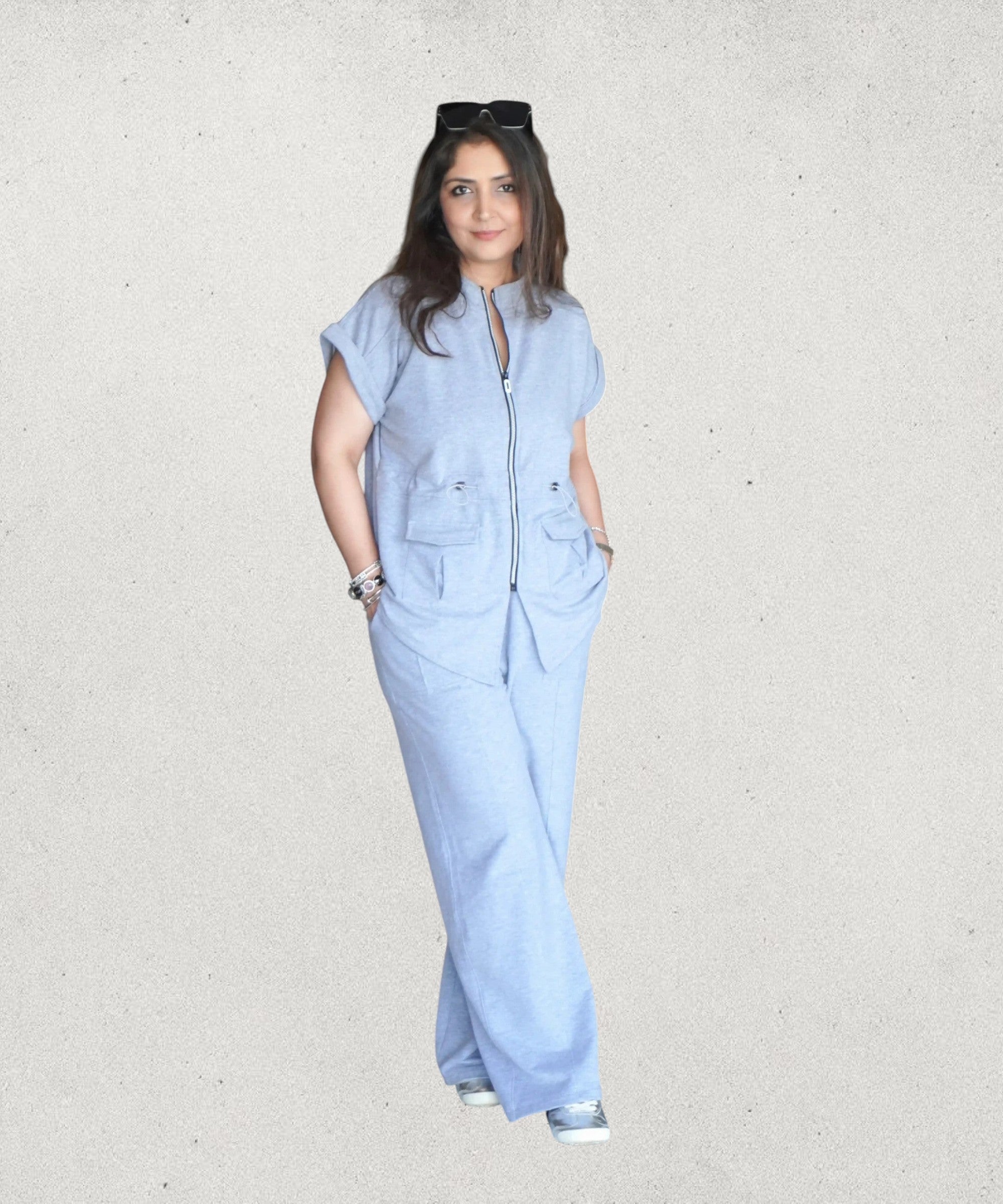 Tuna Active light blue linen-blend zippered utility jumpsuit with wide legs and patch pockets, worn by a woman indoors.