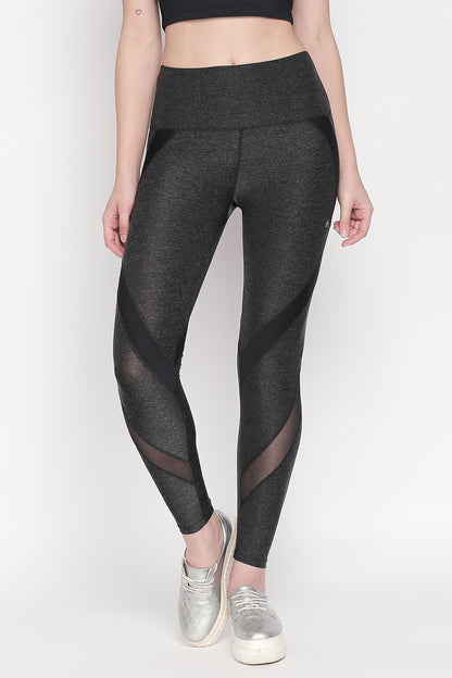 Woman wearing Grey High Waisted Sports Leggings LG14 with mesh panels, a black crop top, and silver slip-on shoes for ultimate workout comfort.
