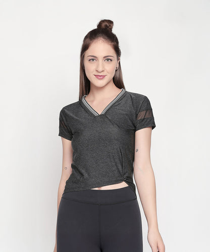 Woman wearing the Active Wear Top in Grey Color for Women and black leggings, standing against a plain white background.