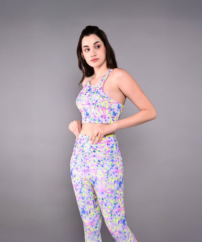 Woman wearing the Multicolor Neon Crop Top, made from skin-friendly cotton lycra, stands sideways against a plain gray background.