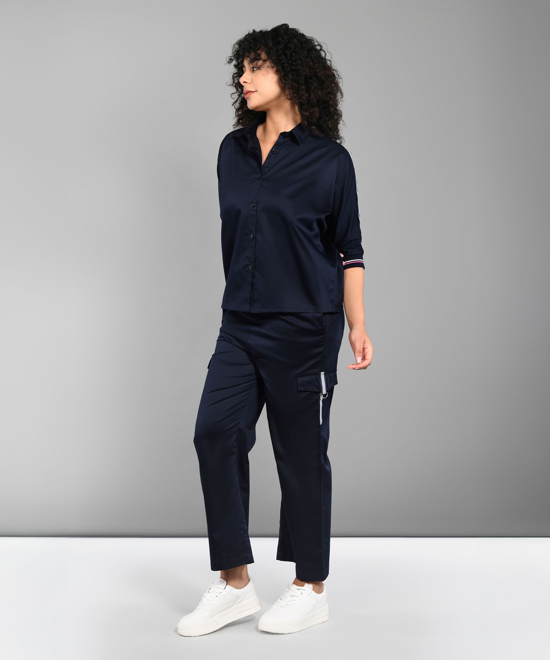 A woman wears the Navy Blue Chic Set—a navy co-ord with a batwing sleeve shirt and matching pants—standing against a plain gray background.