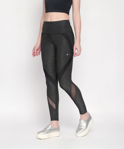 Woman wears Grey High Waisted Sports Leggings LG14 paired with a black crop top and silver platform sneakers on a white background.