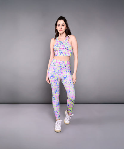 Woman in a comfortable, skin-friendly Multicolor Neon Crop Top and white sneakers poses against a plain gray background.