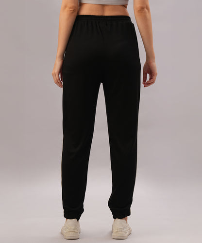 Model wears the Black Co-Ord Set, seen from the back against a plain background—a sleek, coordinated outfit made from comfortable cotton lycra and styled with white sneakers.