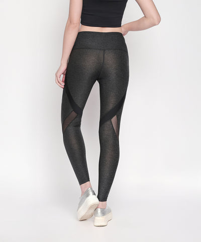 A woman in Grey High Waisted Sports Leggings LG14 with mesh panels and a black crop top stands against a white background.