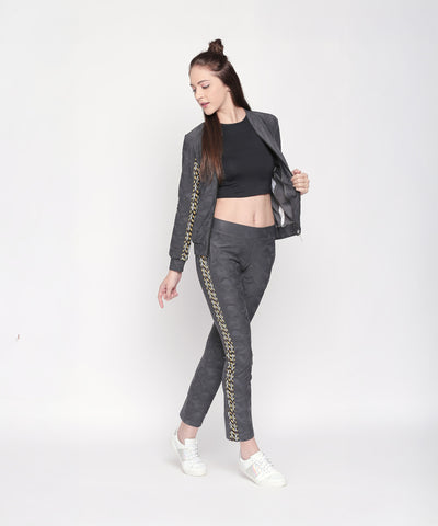 Confidently posing in Self Printed Grey TrackPants, black crop top, and white sneakers, this look showcases effortless athleisure style—perfect for refreshing your women’s trackpants collection.