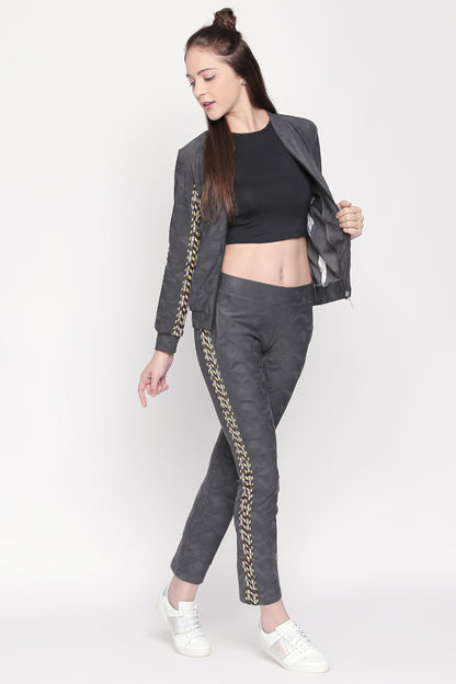 Woman wearing the Active Wear Printed Jacket in Grey, featuring patterned stripes and a comfortable polyester blend, poses with one hand out against a white background.