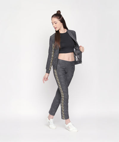 Woman in a black crop top and Active Wear Printed Jacket in Grey with matching pants, posing against a plain white background—a chic look for women seeking grey jackets.