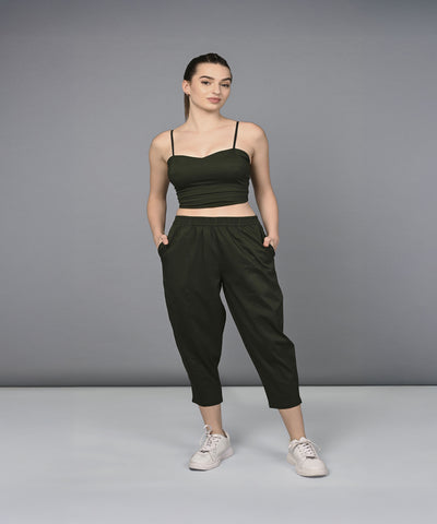 A woman models the Military Green Open Jacket & Yoga Pants with Bustiere set, standing with hands in pockets against a plain gray background.