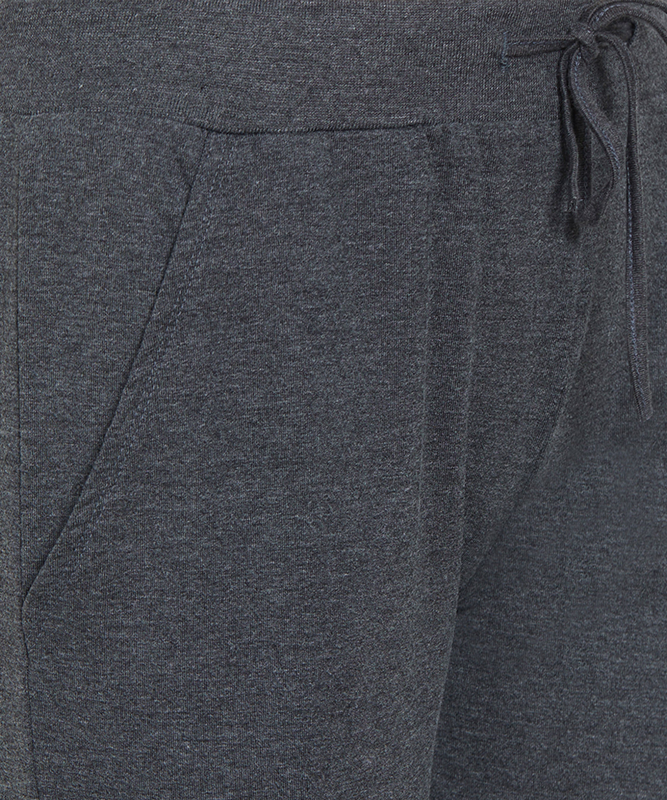 Close-up of Joggers - Ashtanga Series Grey by TUNA LONDON for women, featuring a dark gray color, drawstring waist, and visible front pocket.