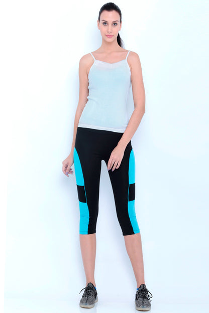 The Capri TLC66 features comfortable Cotton Spandex fabric and a stylish design with black capri length and blue panels. Worn here with a white tank top—perfect for daily workouts against any backdrop.