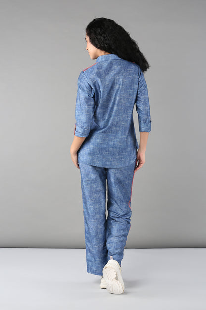 A person stands facing away on a plain gray background, wearing the Denim Linen Co-Ord Set.
