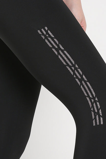 Close-up of Tuna Active Black Leggings With Print, crafted from premium stretch fabric and featuring a geometric reflective stripe on the thigh—ideal for yoga, gym, sports, or fitness activities.