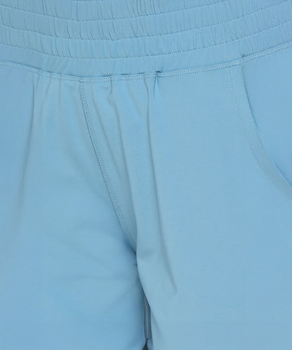 Close-up of Tuna Active Blue Joggers showcasing an elastic waist, visible pockets, and detailed stitching for a comfortable fit.