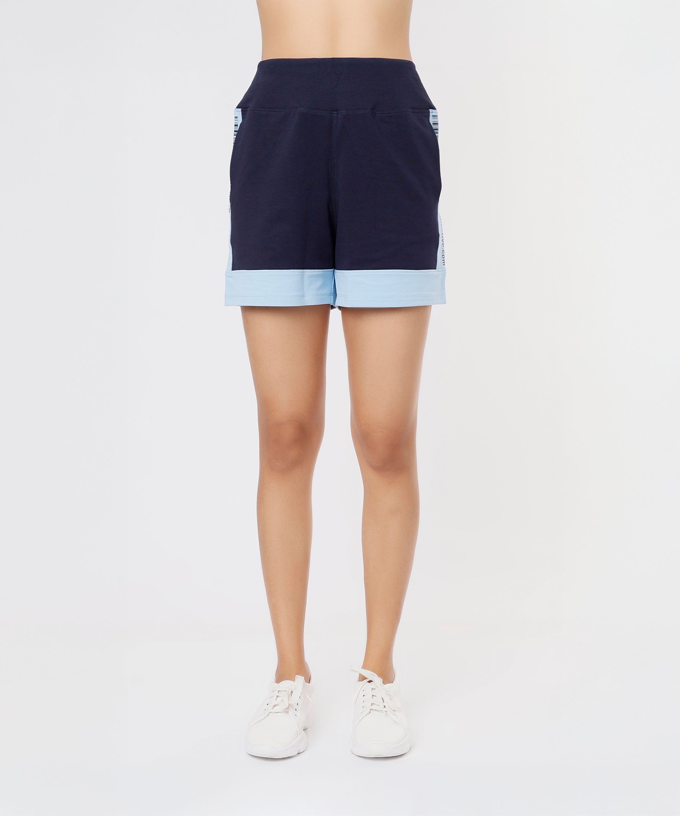 A person wearing Tuna Active Barcode Printed Blue Shorts and white sneakers, standing against a white background.