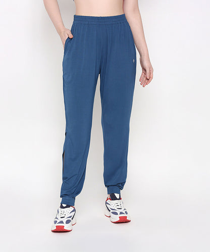 Person wearing Atlantic Blue Active Duo joggers and white sneakers, standing against a plain light background.