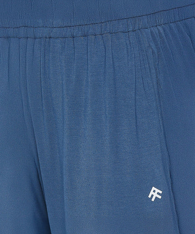 Close-up of Atlantic Blue Active Duo joggers with an elastic waistband, crafted from buttery soft fabric and featuring a small white "RF" logo on the pocket.