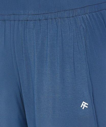 Close-up of Atlantic Blue Active Duo joggers with an elastic waistband, crafted from buttery soft fabric and featuring a small white "RF" logo on the pocket.