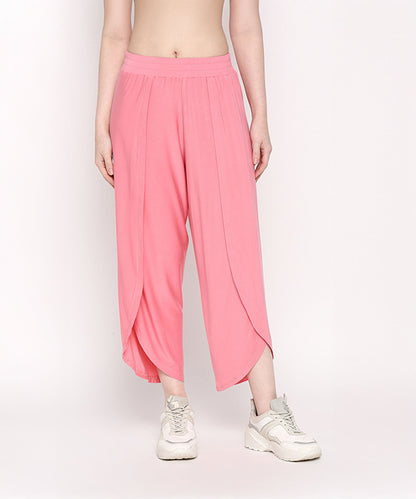 A person wearing the Coral Blissful Tulip Set, made from soft Cotton Modal, paired with white sneakers and standing against a plain light background.