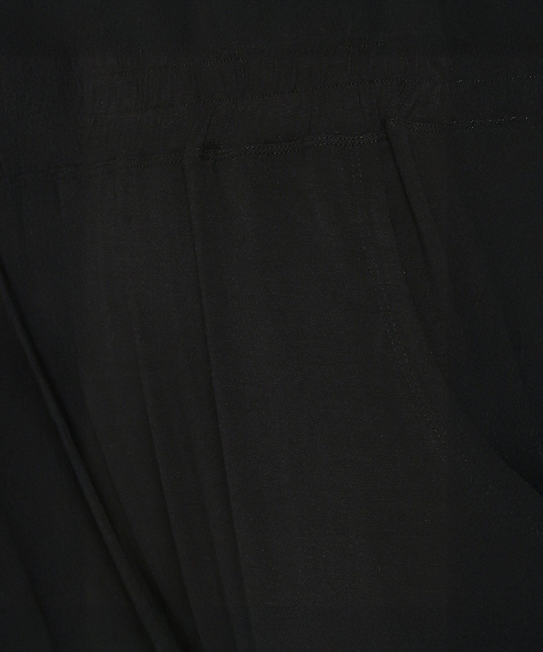 Close-up of buttery soft fabric with visible stitching and a seam, likely from the Versatile Black Ensemble.