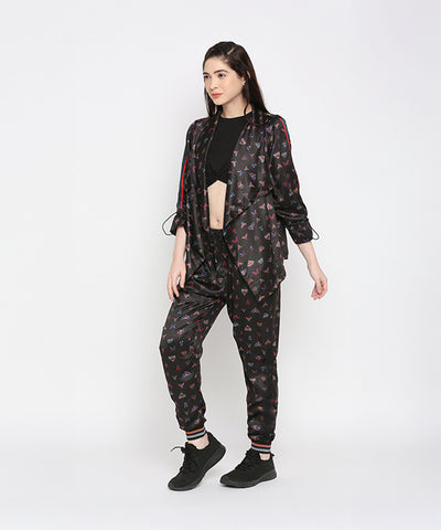 Woman in a black crop top and Tuna Active Butterfly Joggers, standing against a white background.