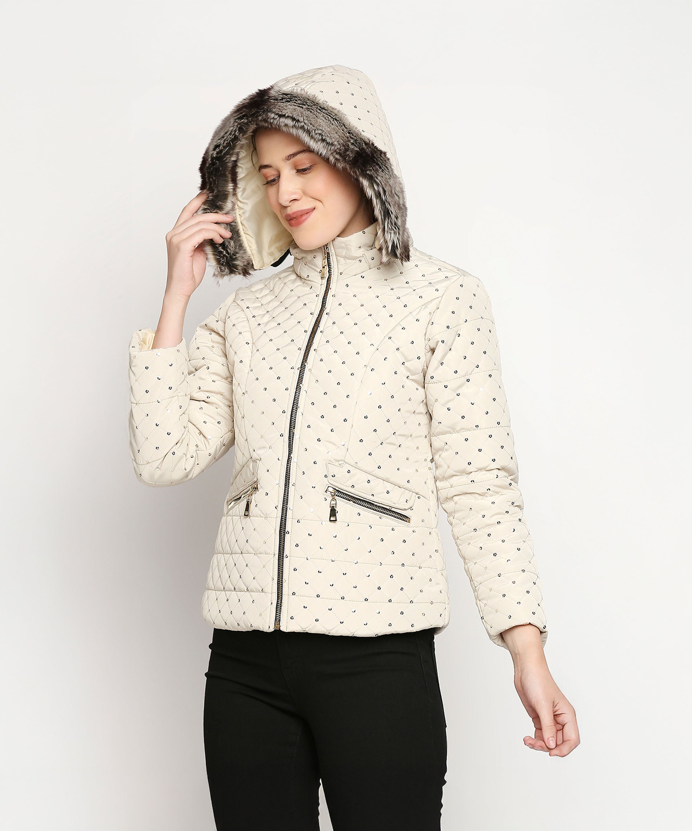 Smiling woman with closed eyes wears an Off White Mid Length High Collar Puffer Jacket with Detachable Fur Hoodie and black pants.