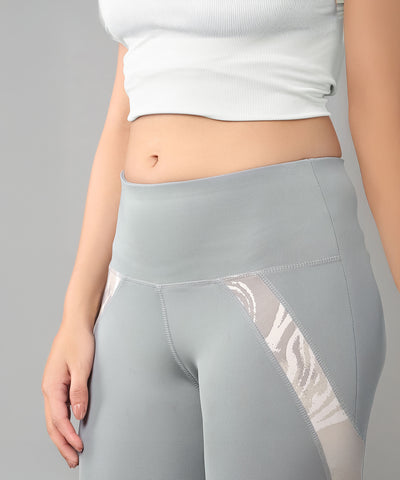 Woman in a Grey Top with Patched Legging, featuring moisture-wicking fabric to keep you cool while showing off your midriff.
