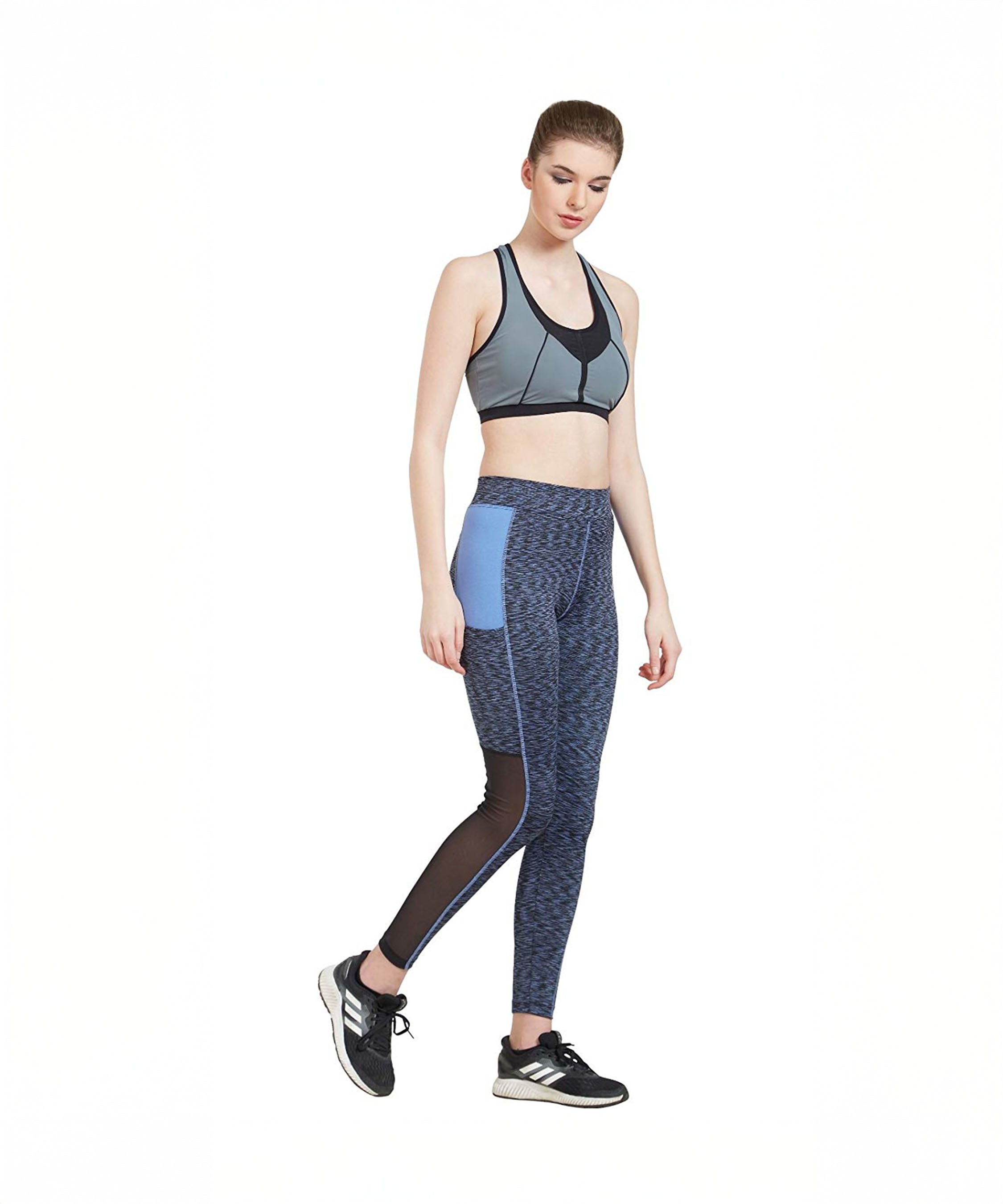 Woman in activewear, featuring Blue Poly Cotton Lycra Printed Slim Fit Track Pant for Women, walking against a white background.
