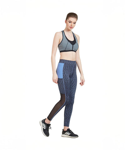 Woman in activewear, featuring Blue Poly Cotton Lycra Printed Slim Fit Track Pant for Women, walking against a white background.