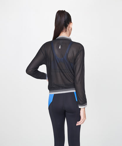 A woman wearing the Black Sheer Bomber Jacket With Leggings, featuring a black mesh long-sleeve top and matching leggings with blue accents, is shown from the back.