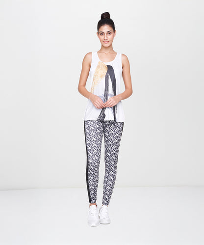 Woman wearing White Printed Leggings stands against a plain white background.